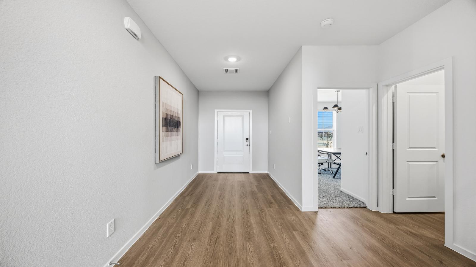 Entry hallway leading to living room and kitchen in the background.