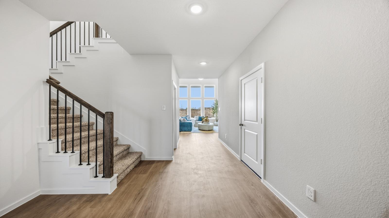 Spacious entry foyer with grand staircase leading to the second floor