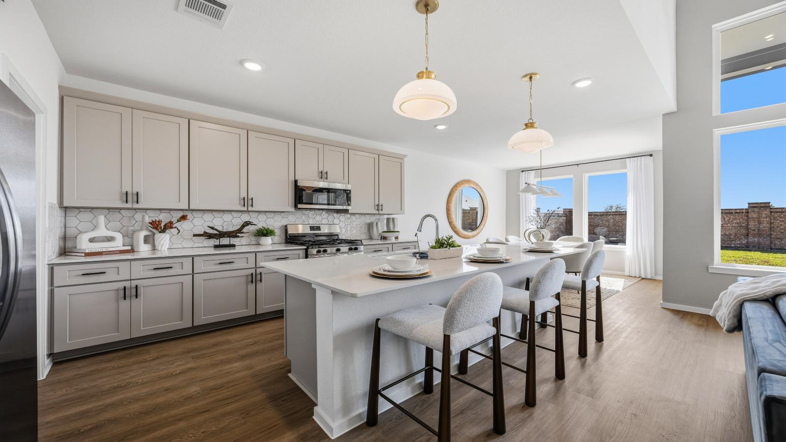 Kitchen adorned with painted cabinets seamlessly integrated into an open dining area layout.