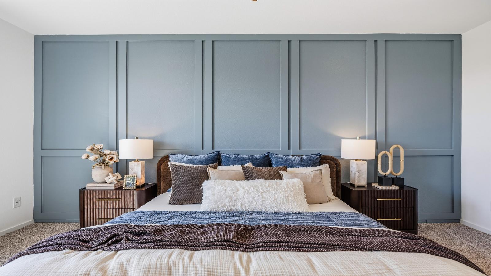 View of the primary bedroom and accent wall in the model home
