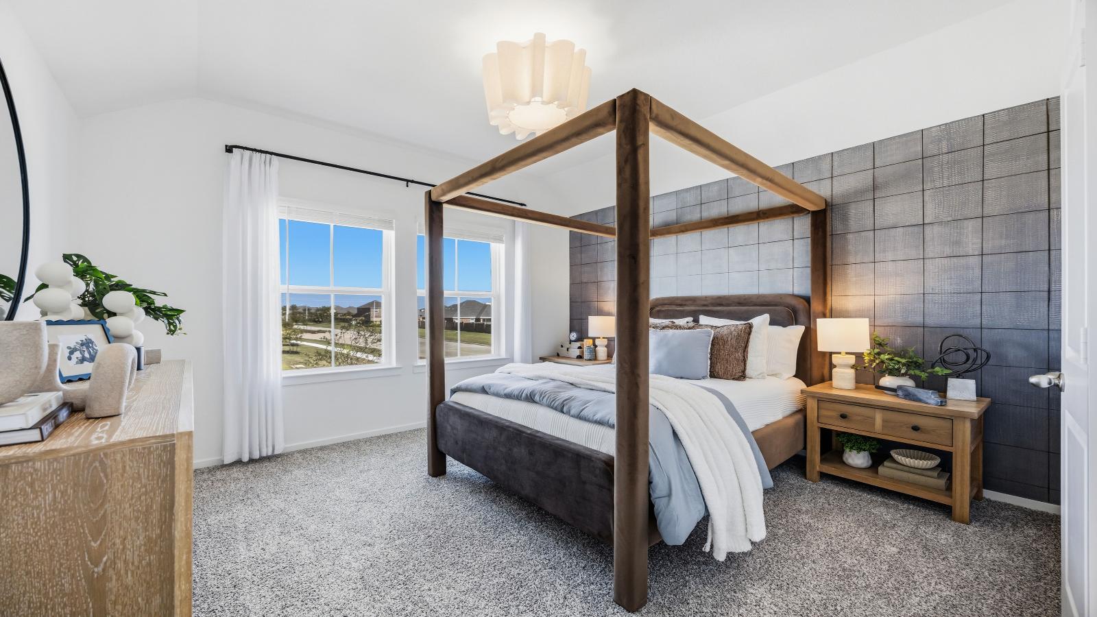 A vibrant bedroom showcasing a neatly made bed, a stylish dresser, and a playful painting that adds charm.