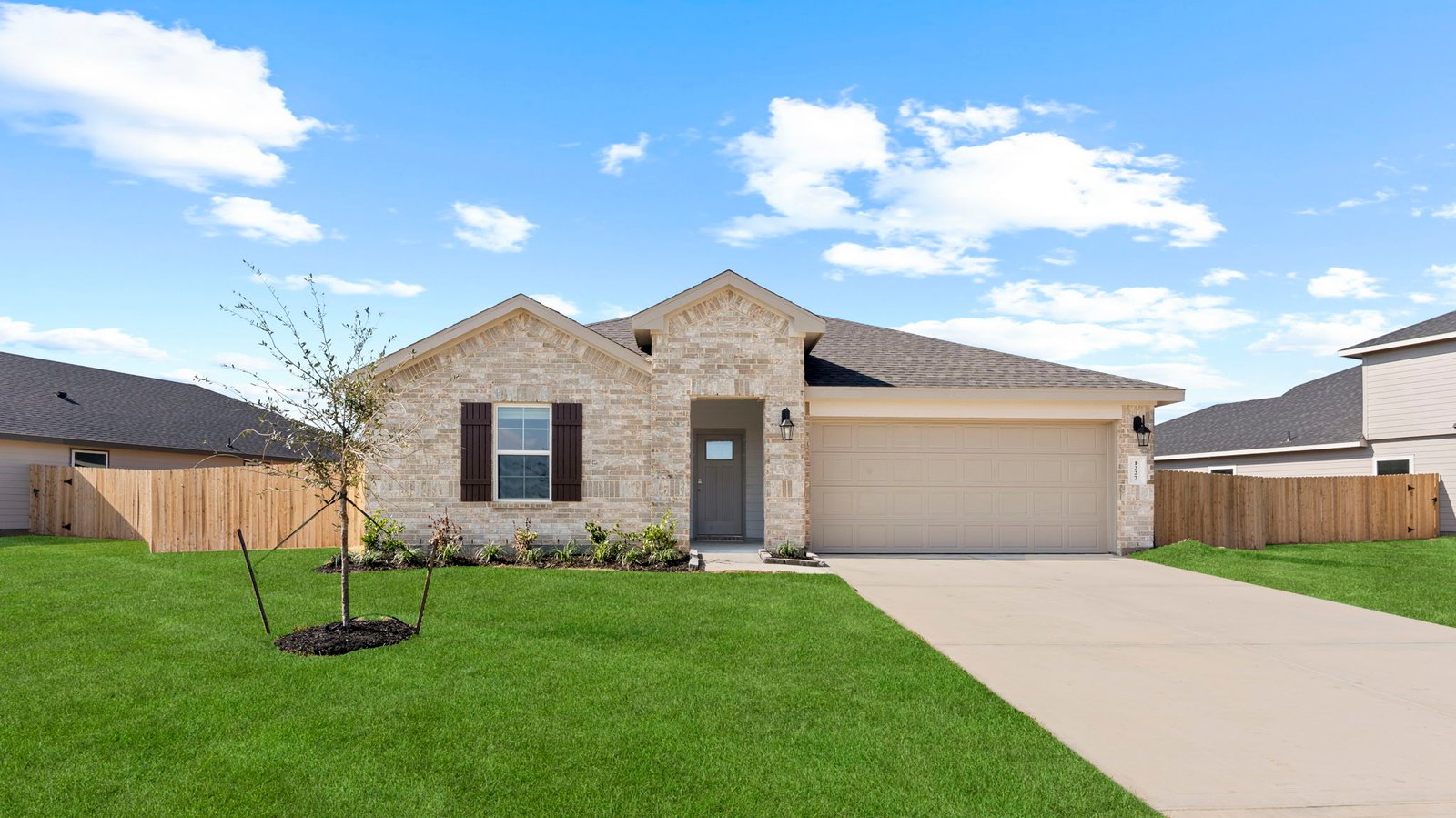 single story brick home with a two car garge
