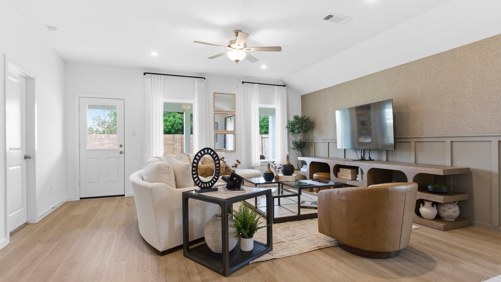A well-organized living room that includes a kitchen and dining area, creating a warm and welcoming environment for gatherings.