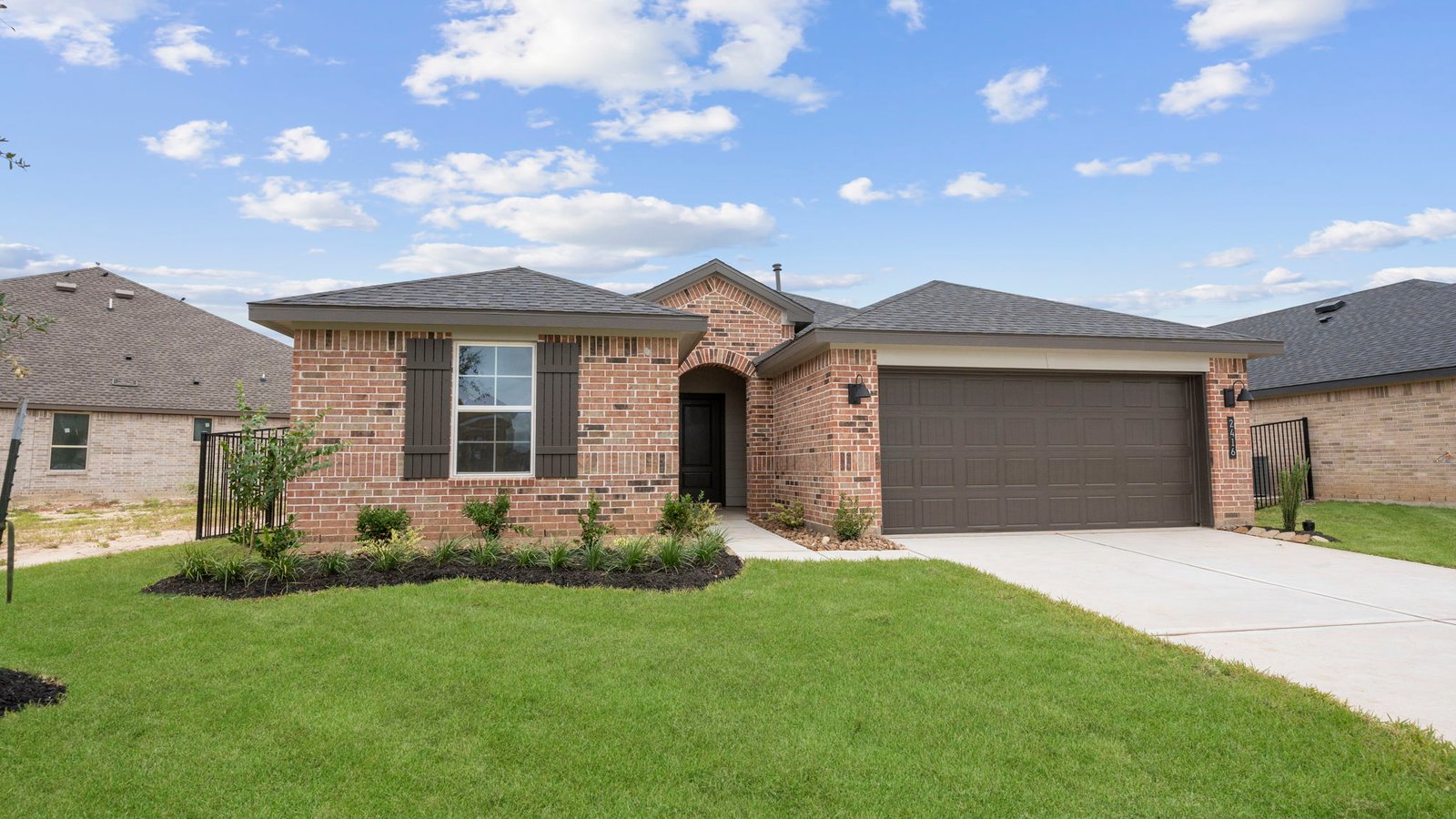 Newly built single story home with traditional architecture, a double garage, and landscaped front yard.