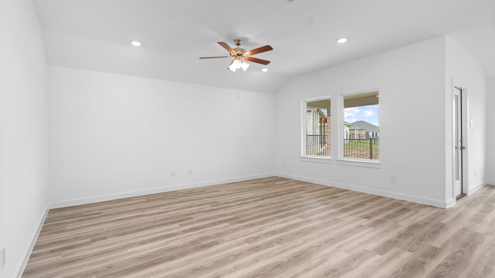 A well-organized living room that includes a kitchen and dining area, creating a warm and welcoming environment for gatherings.