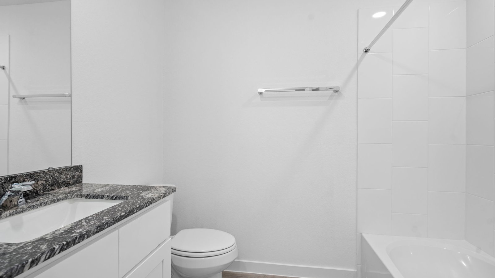 A well-designed bathroom equipped with granite countertops, emphasizing functionality and contemporary style.
