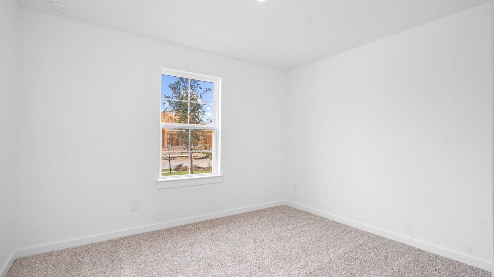 A third bedroom with neutral walls, plush carpet flooring and a separate closet.