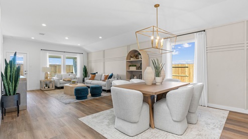 Open concept living room and dining room with three large windows