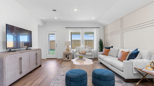 Living room with two large windows and back patio door