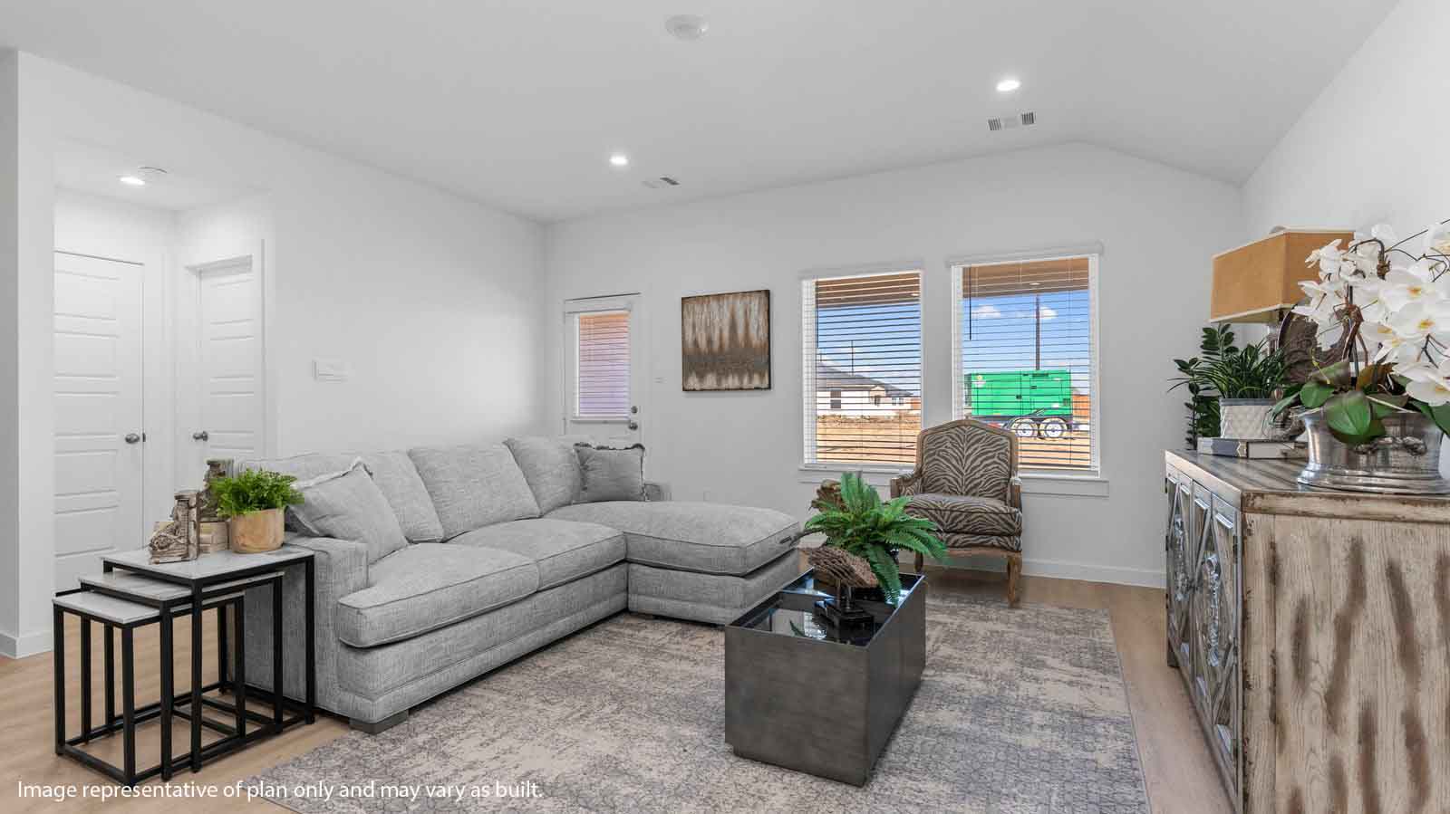 Spacius living room with two large windows and a back patio door