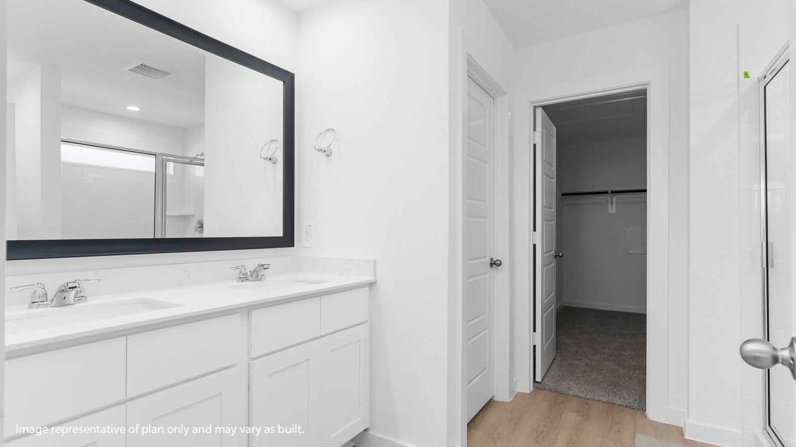 Primary bathroom vanity with two sinks and a large mirror