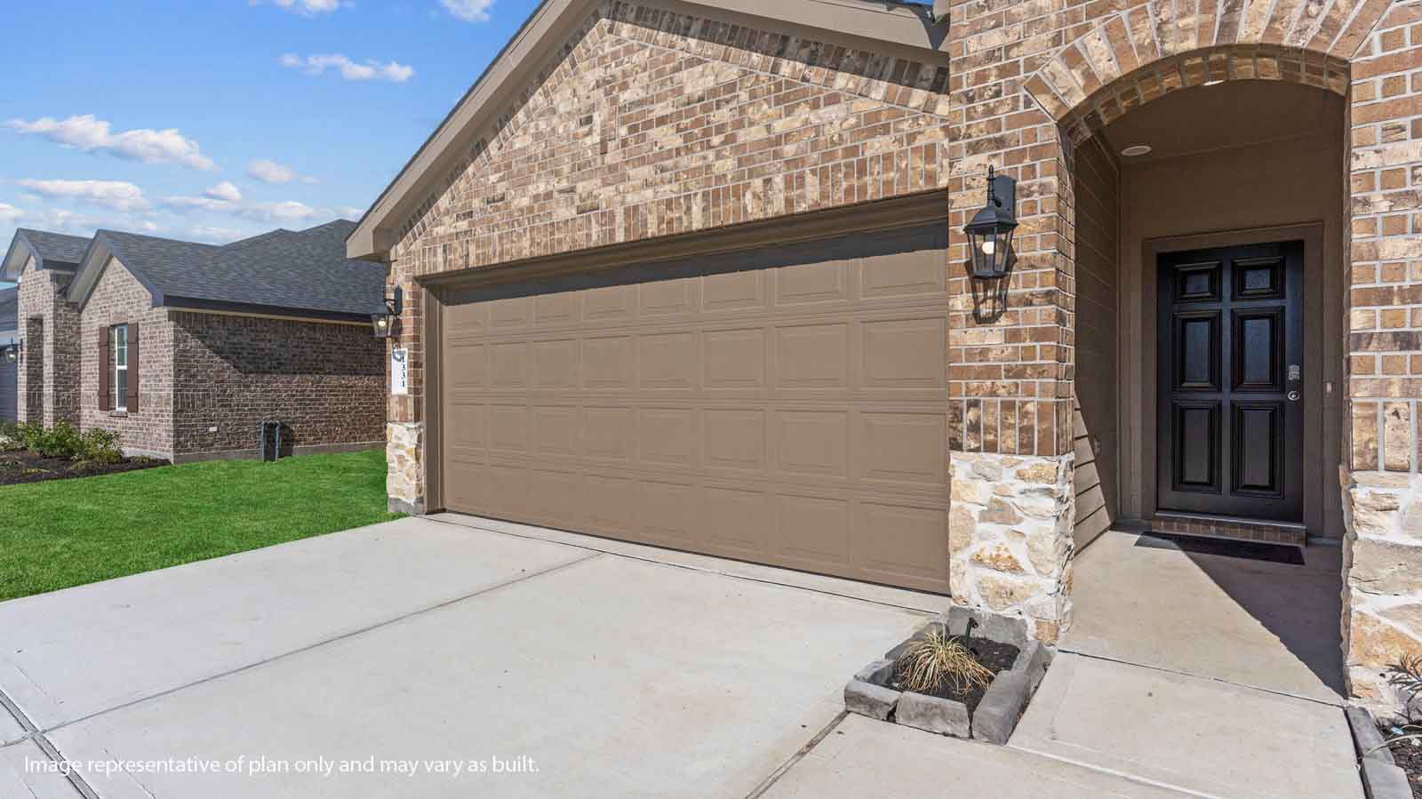 Single story brick home with a two car garage