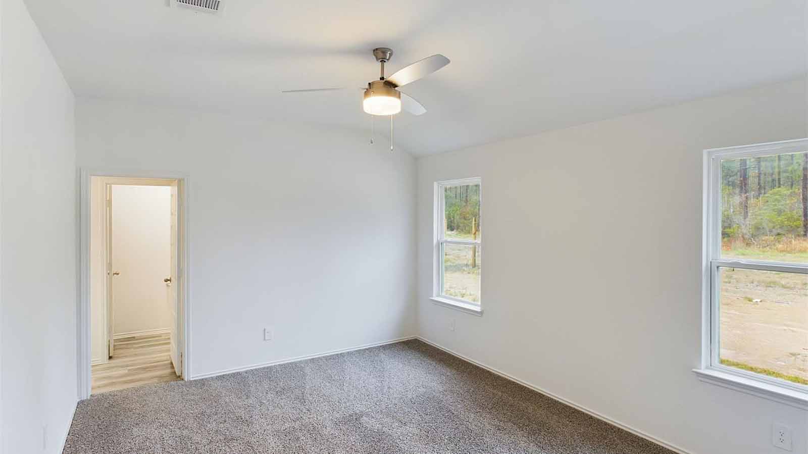 Primary bedroom with two large windows