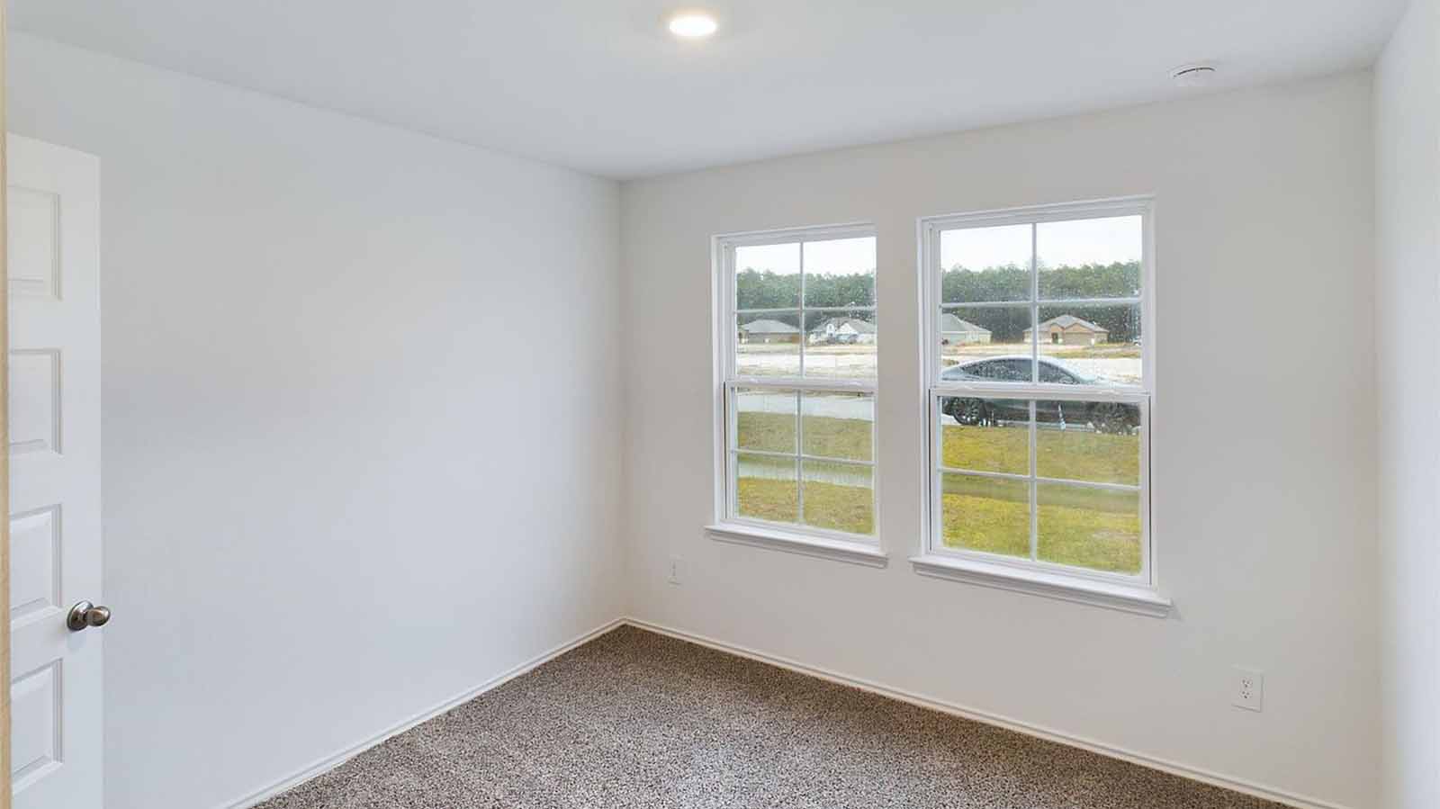 Secondary bedroom with two large windows