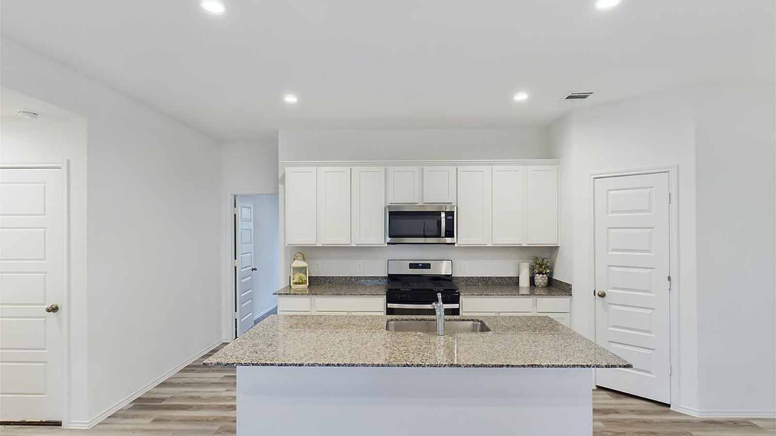 Kitchen with large island featuring a skin
