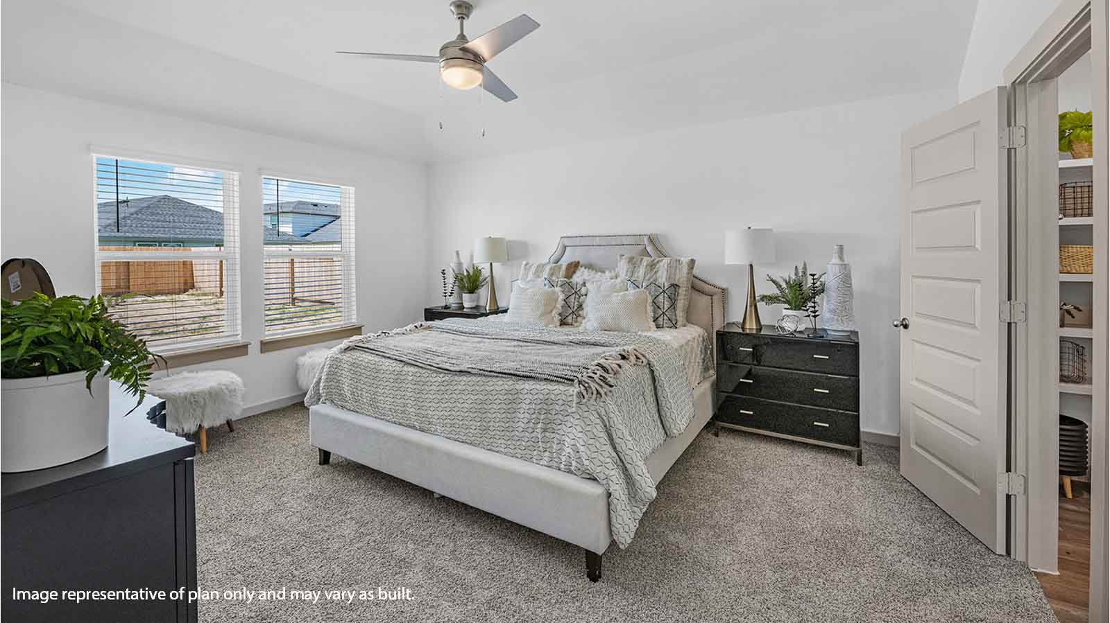 Primary bedroom with two large windows