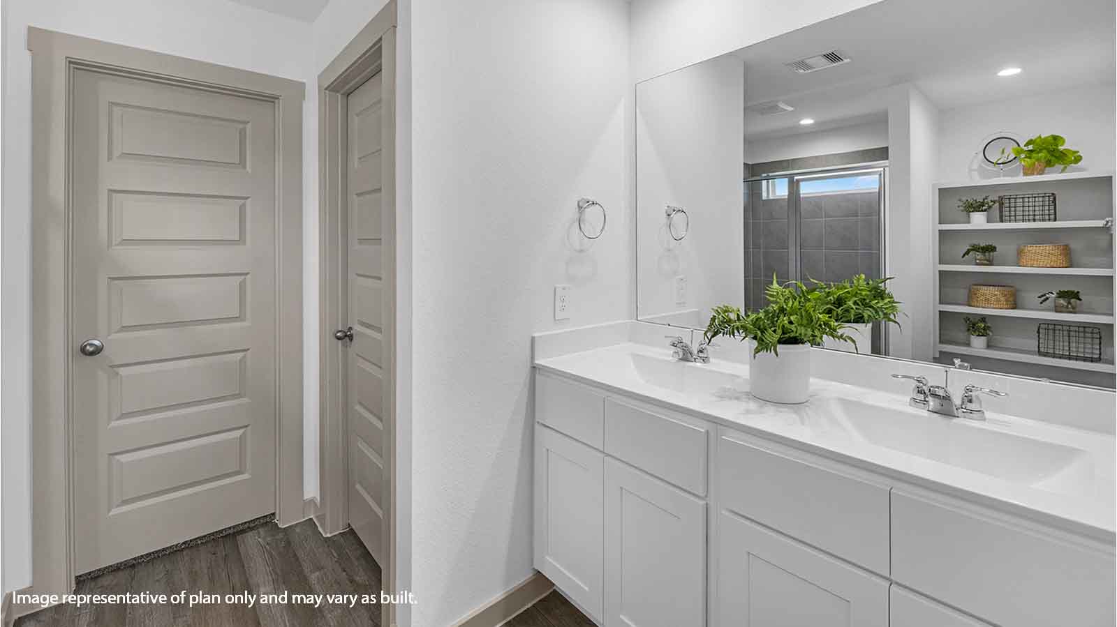 Primary bathroom vanity with two sinks and a large mirror