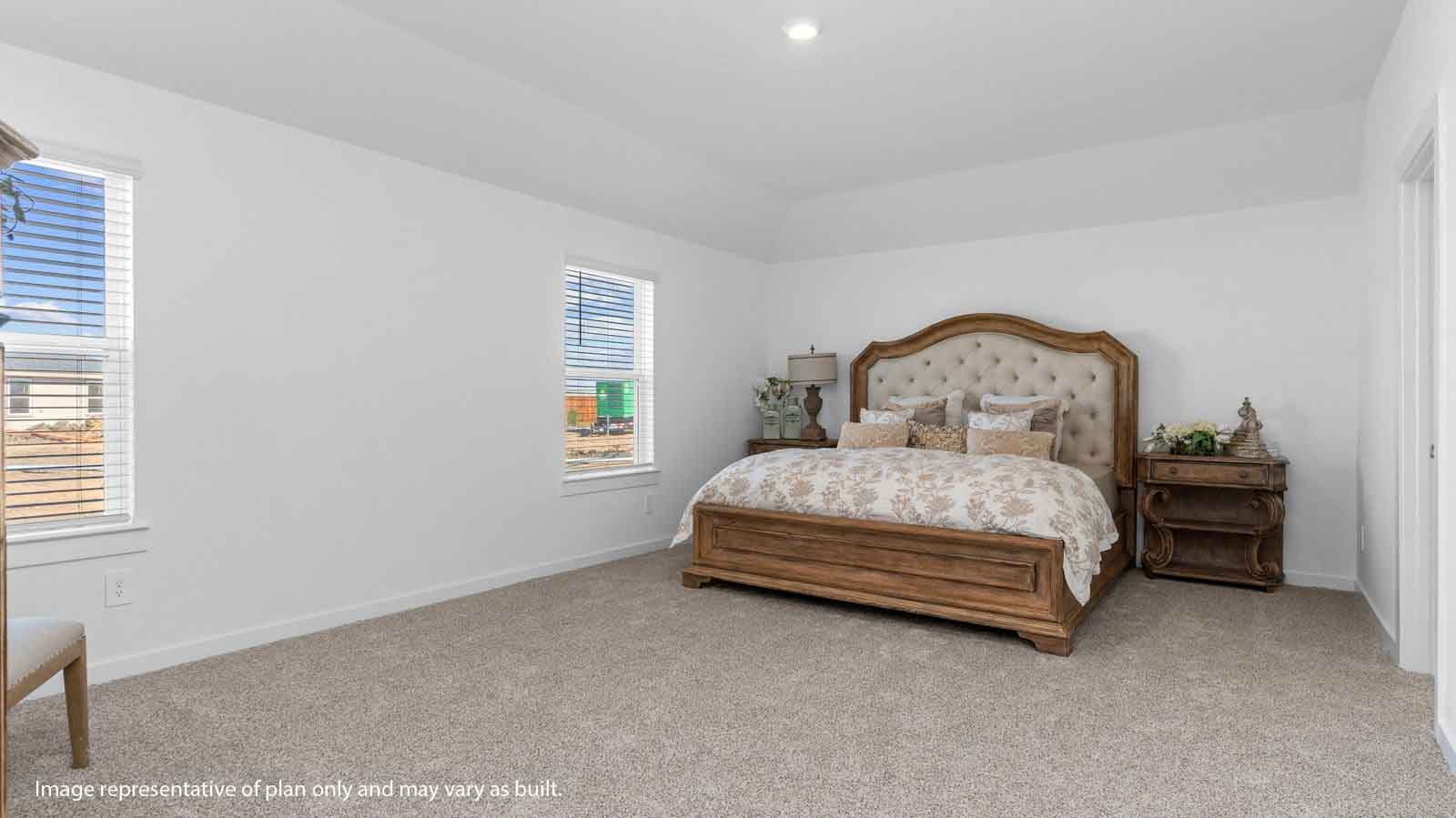 spacious primary bedroom with two windows