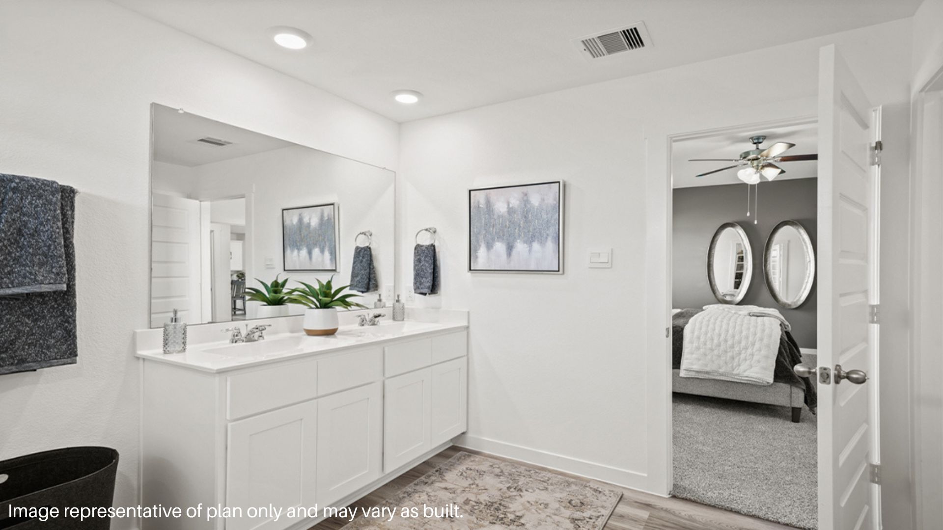Primary bathroom vanity with two sinks and a large mirror