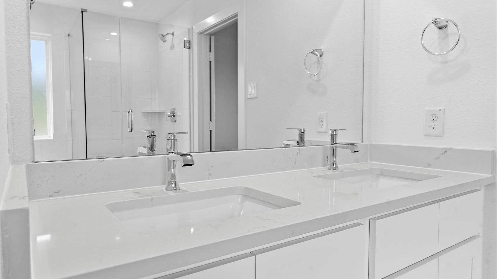primary bathroom vanity with two sinks