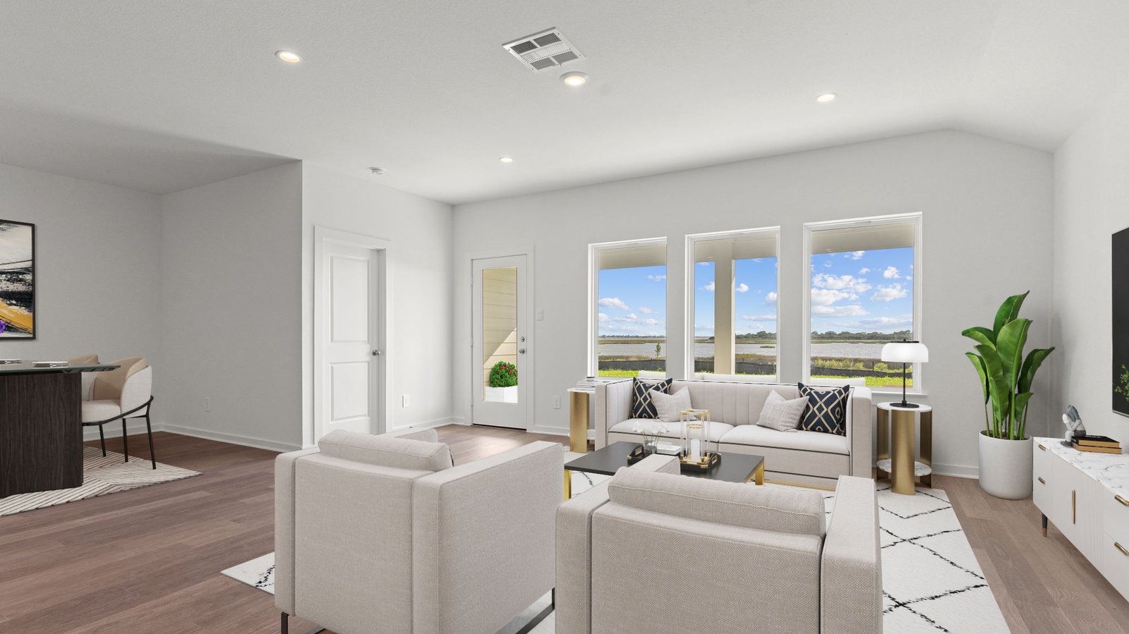 living area with large windows virtually staged with furniture