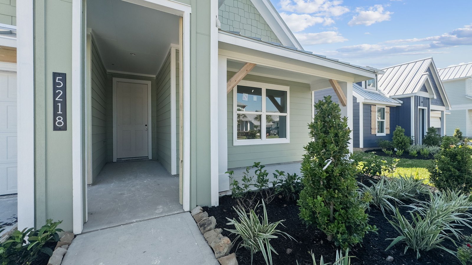 front porch of the one story justin plan located on the water grand cay harbour