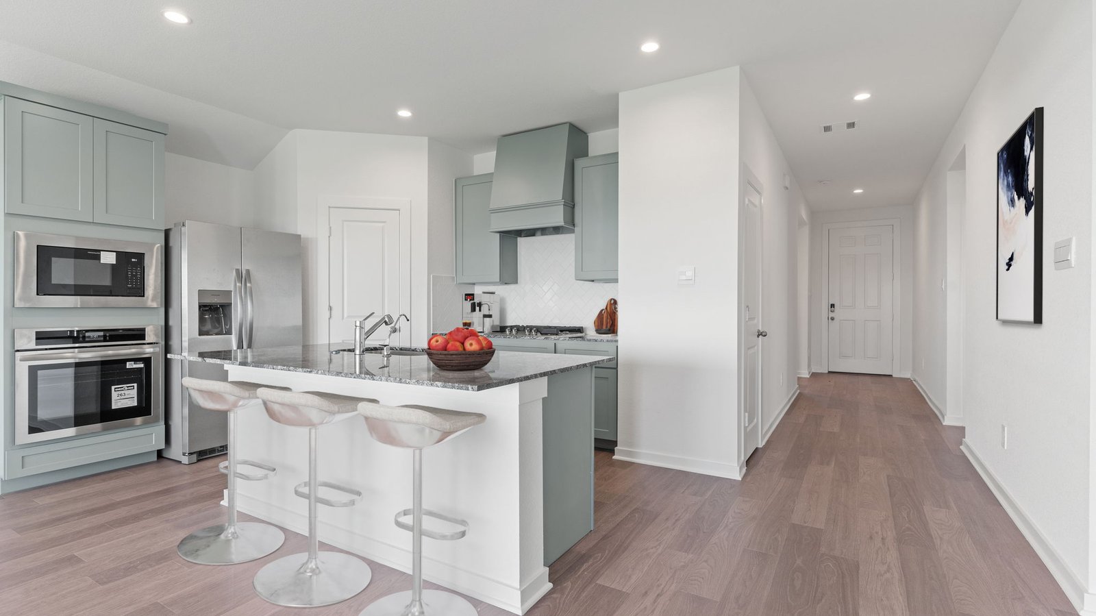 Interior kitchen with center island and light grey cabinets