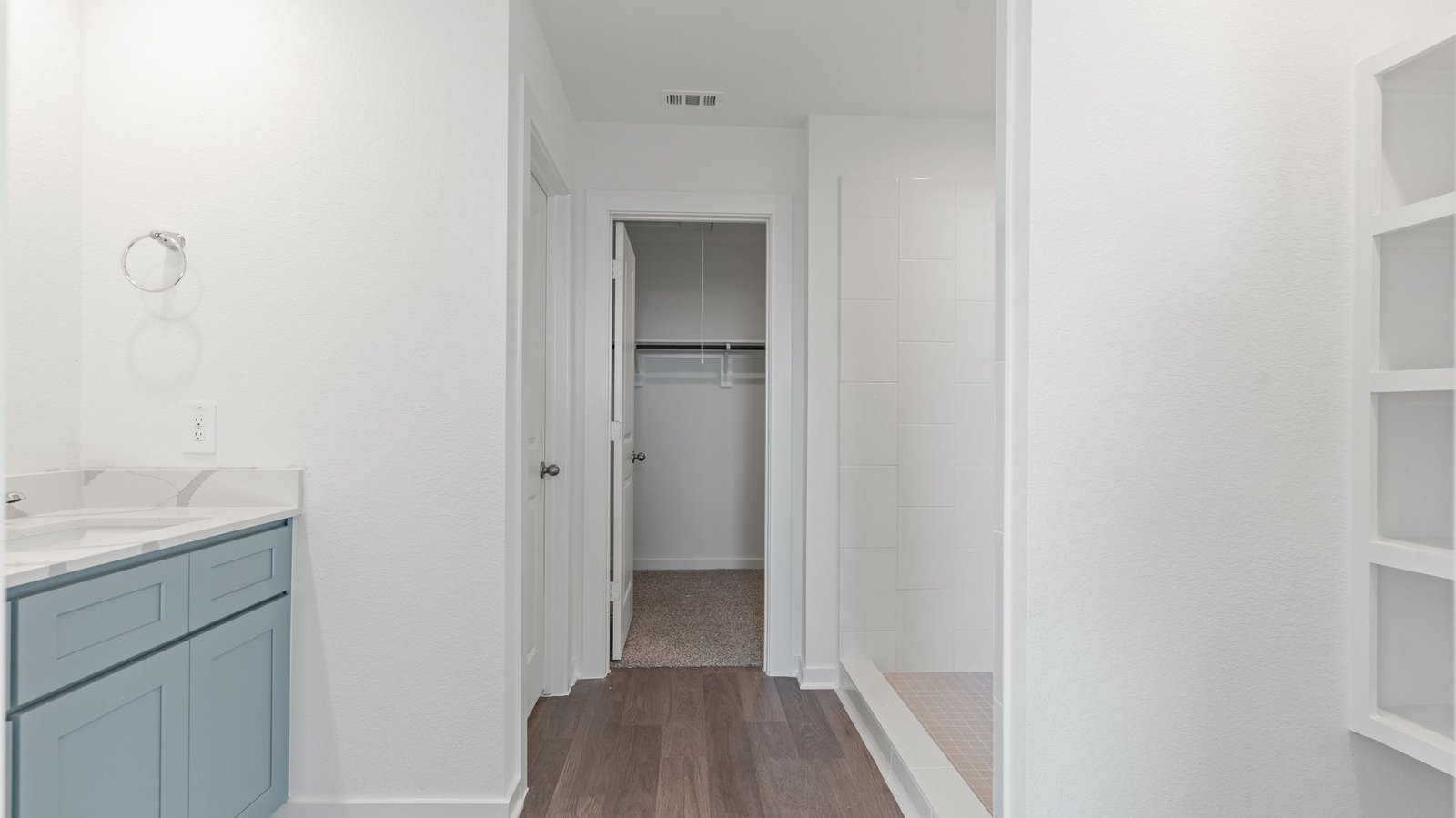 Interior bathroom with sink and walk-in closet