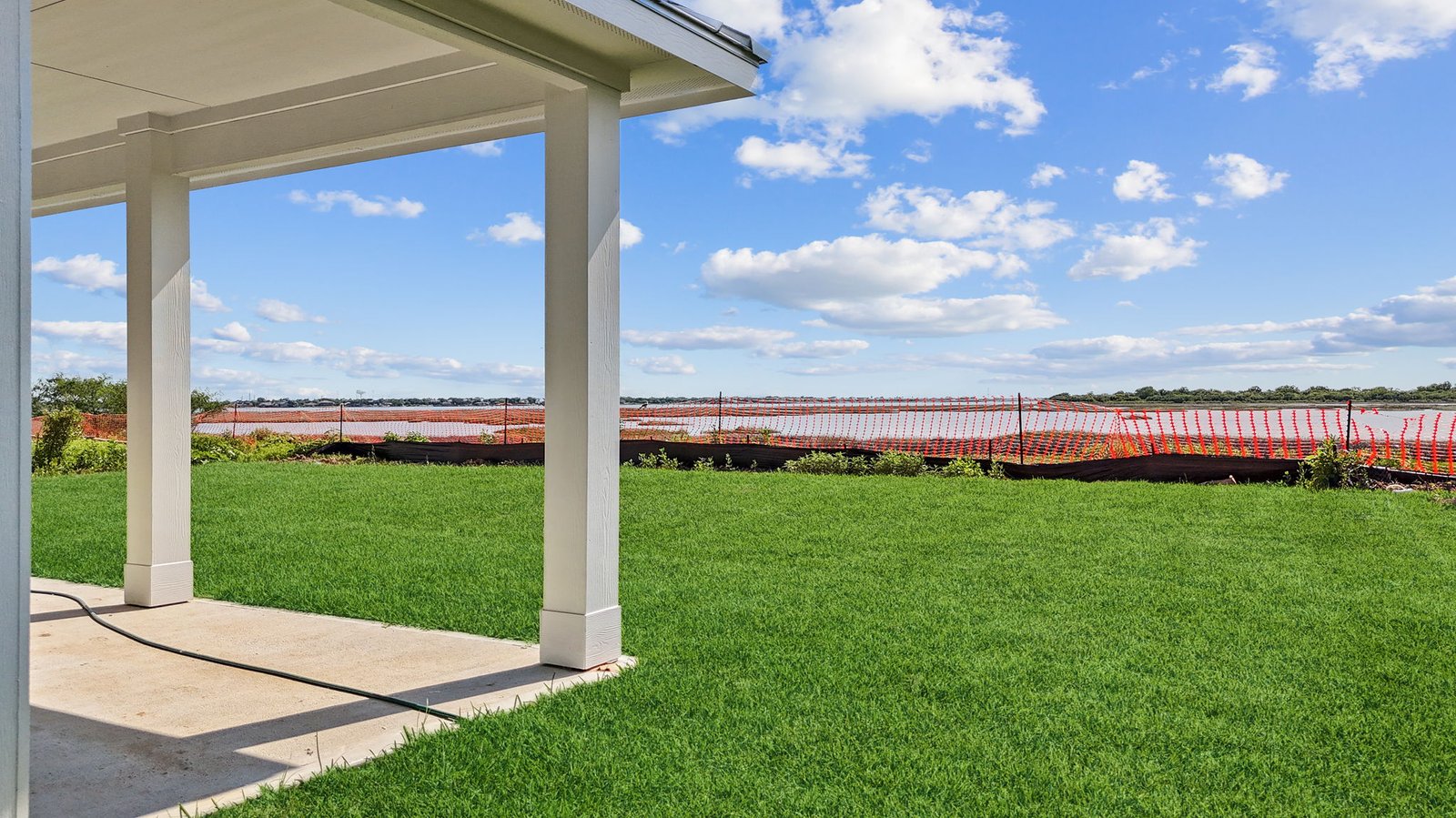 Covered back patio and backyard with sod