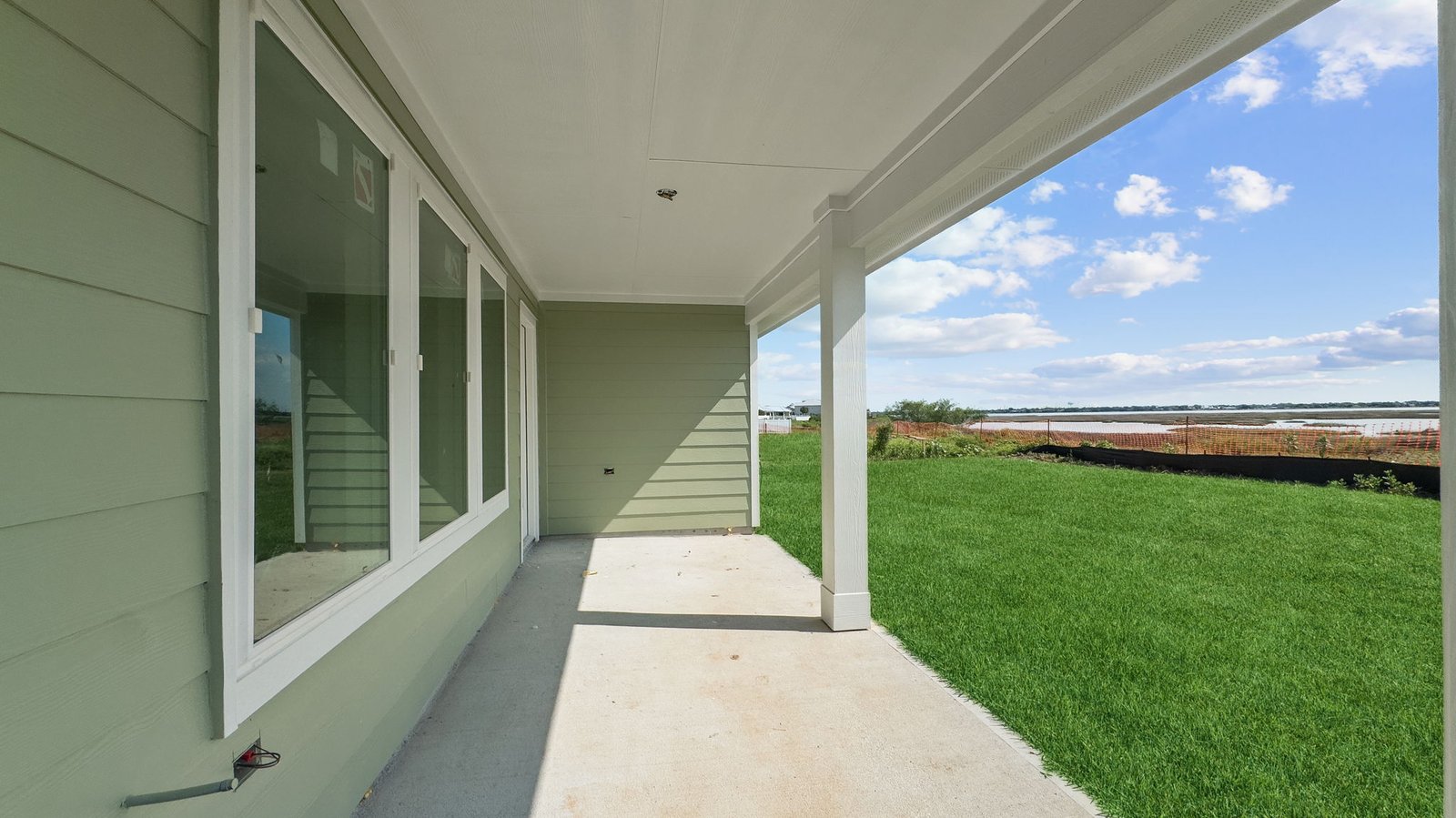 Covered back patio and backyard with sod