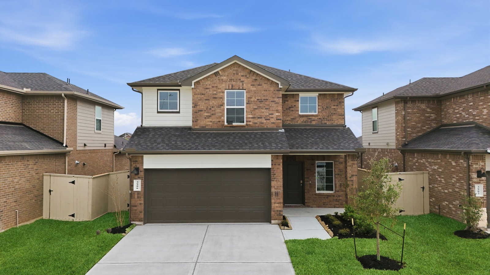 two story home with brick and vinyl exterior with a two car garage