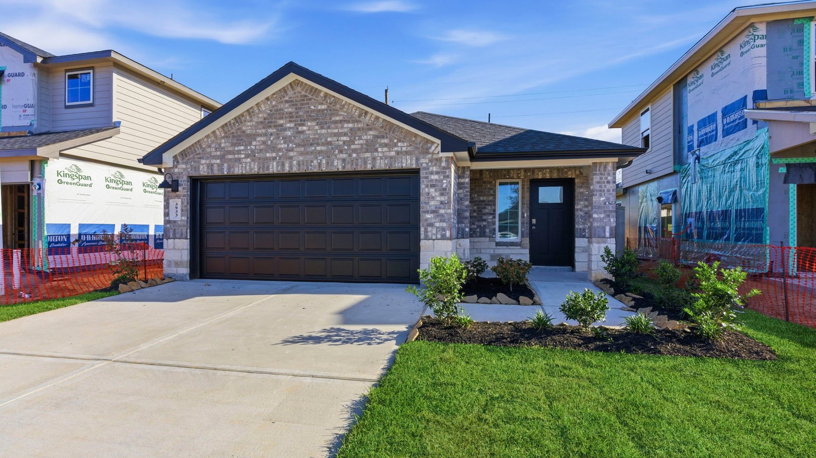 Newly built single story home with traditional architecture, a double garage, and landscaped front yard.