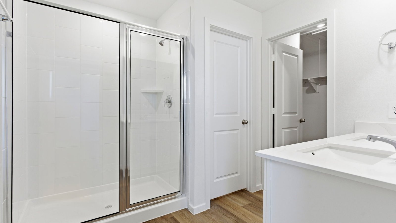 Primary bathroom with a glass-enclosed standing shower and separate soaking tub.