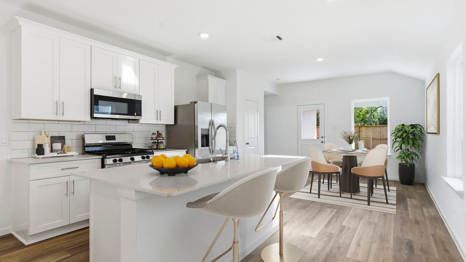 Bright and spacious kitchen with granite countertops, stainless steel appliances, and an island with bar seating.