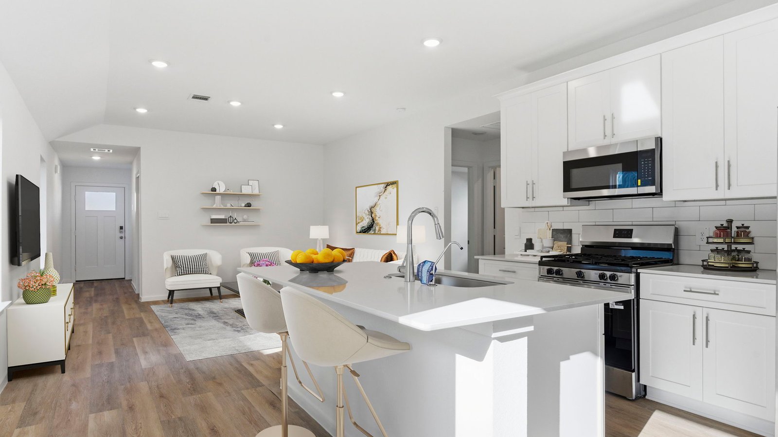 Kitchen adorned with white cabinets seamlessly integrated into an open dining area layout.