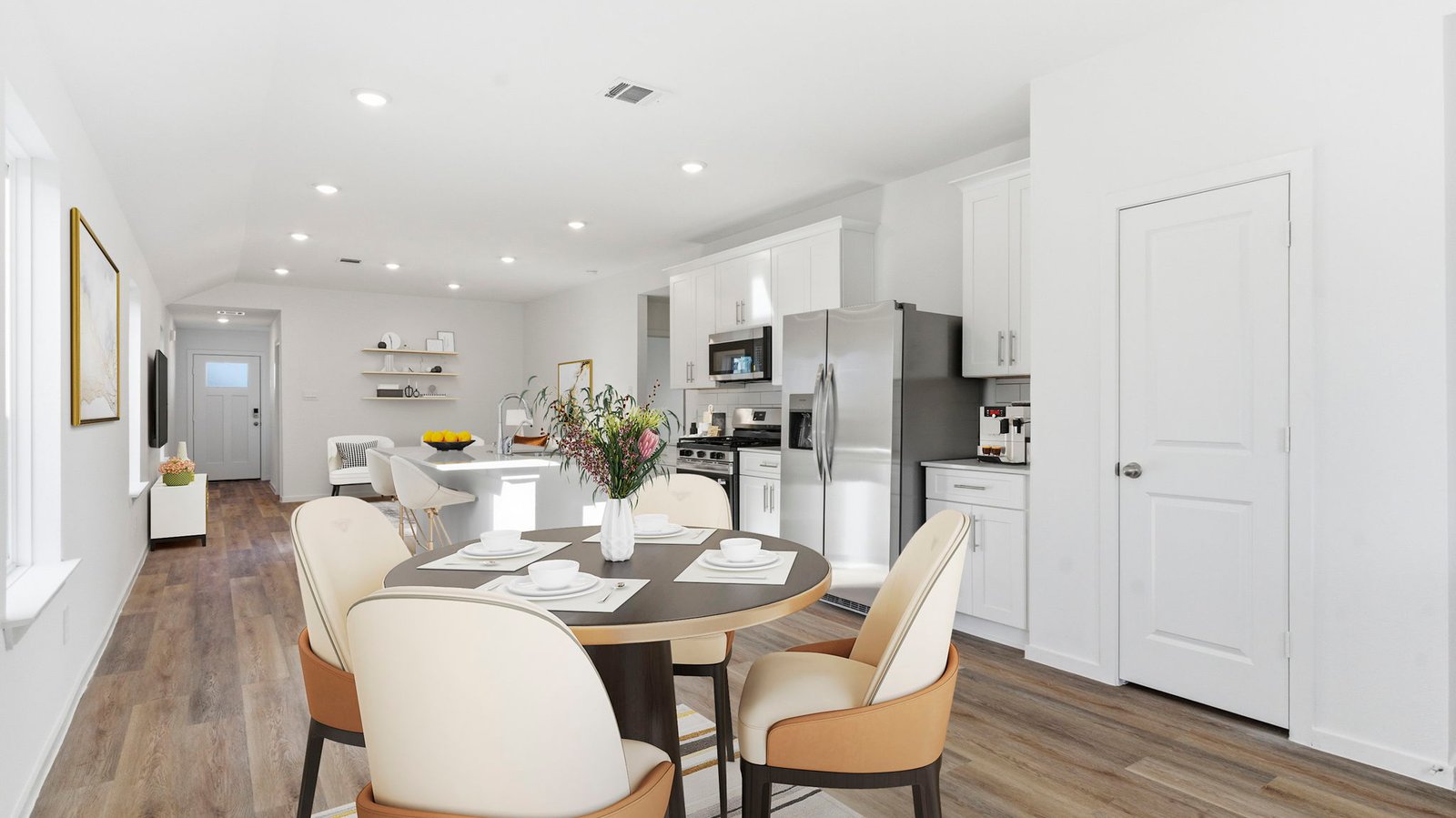 Spacious open concept dining area with vinyl wood flooring and access to the living and kitchen areas