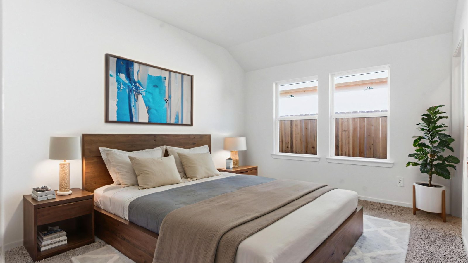 A spacious primary bedroom emphasizing open space and natural lighting with large windows.