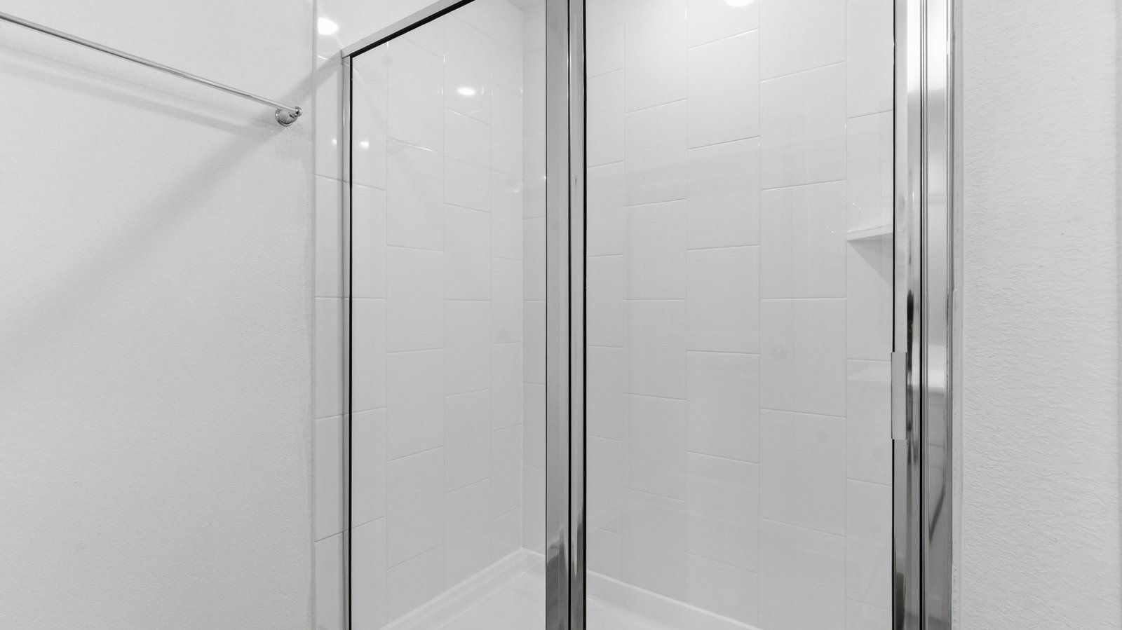 Primary bathroom with a glass-enclosed standing shower and separate soaking tub.