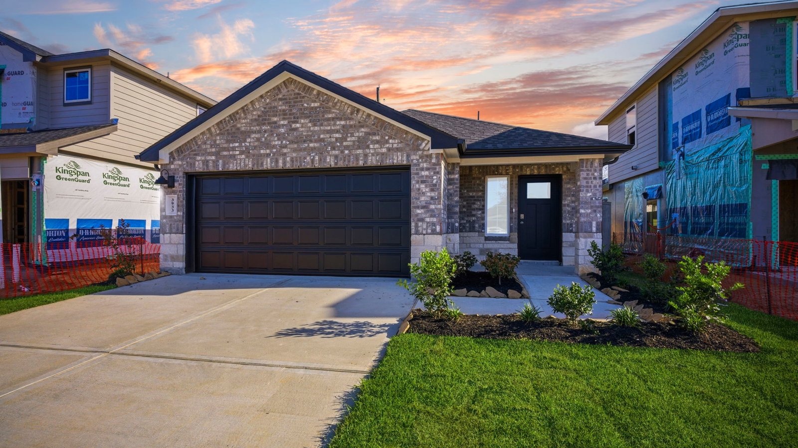 Newly built single story home with traditional architecture, a double garage, and landscaped front yard