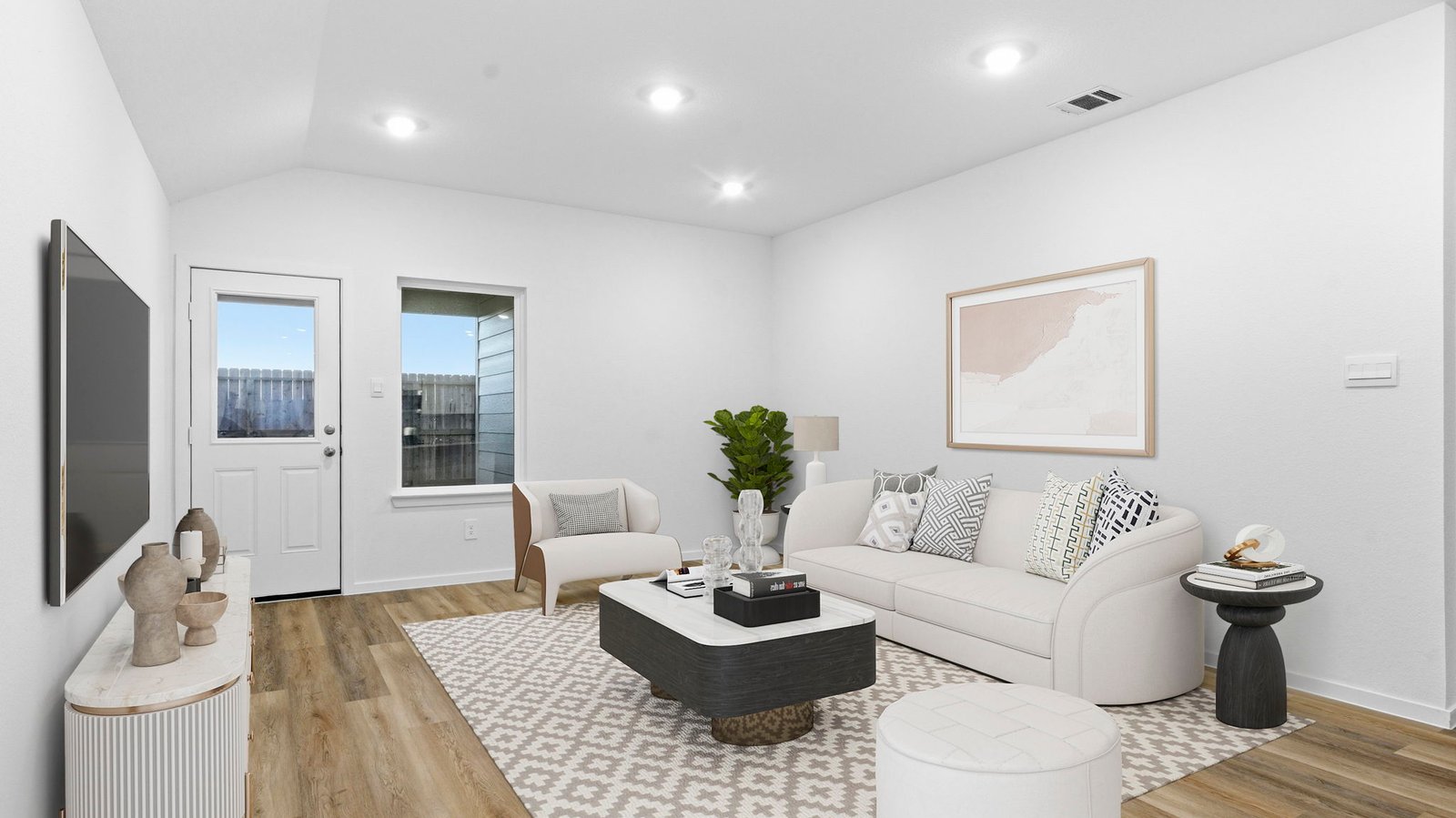 A well-organized living room that includes a kitchen and dining area, creating a warm and welcoming environment for gatherings.