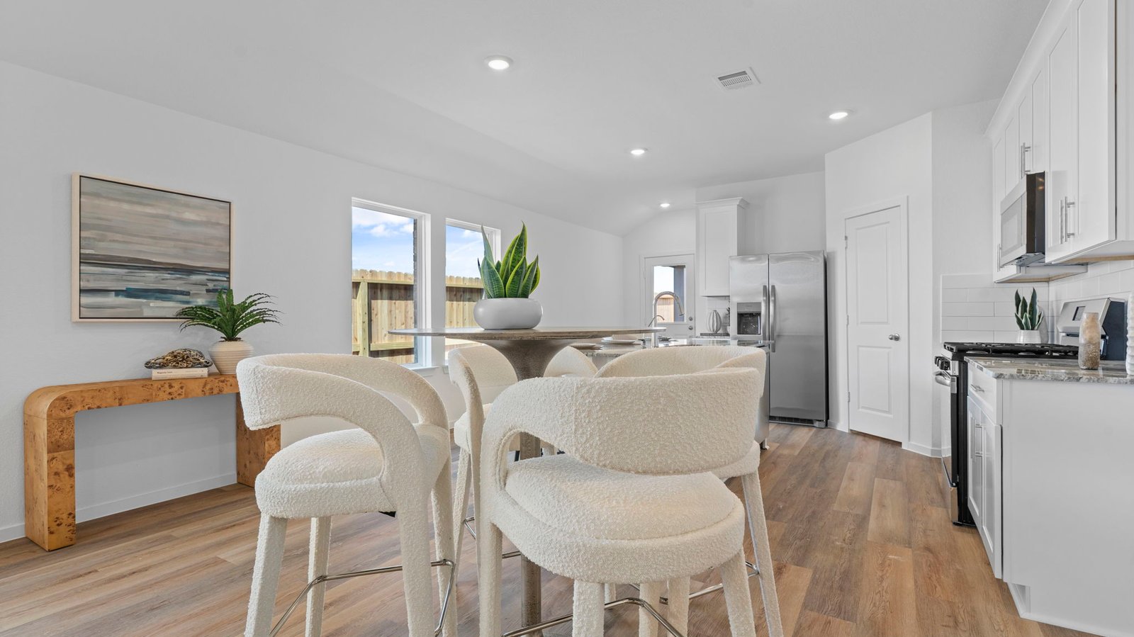 Spacious open concept dining area with vinyl wood flooring and access to the living and kitchen areas