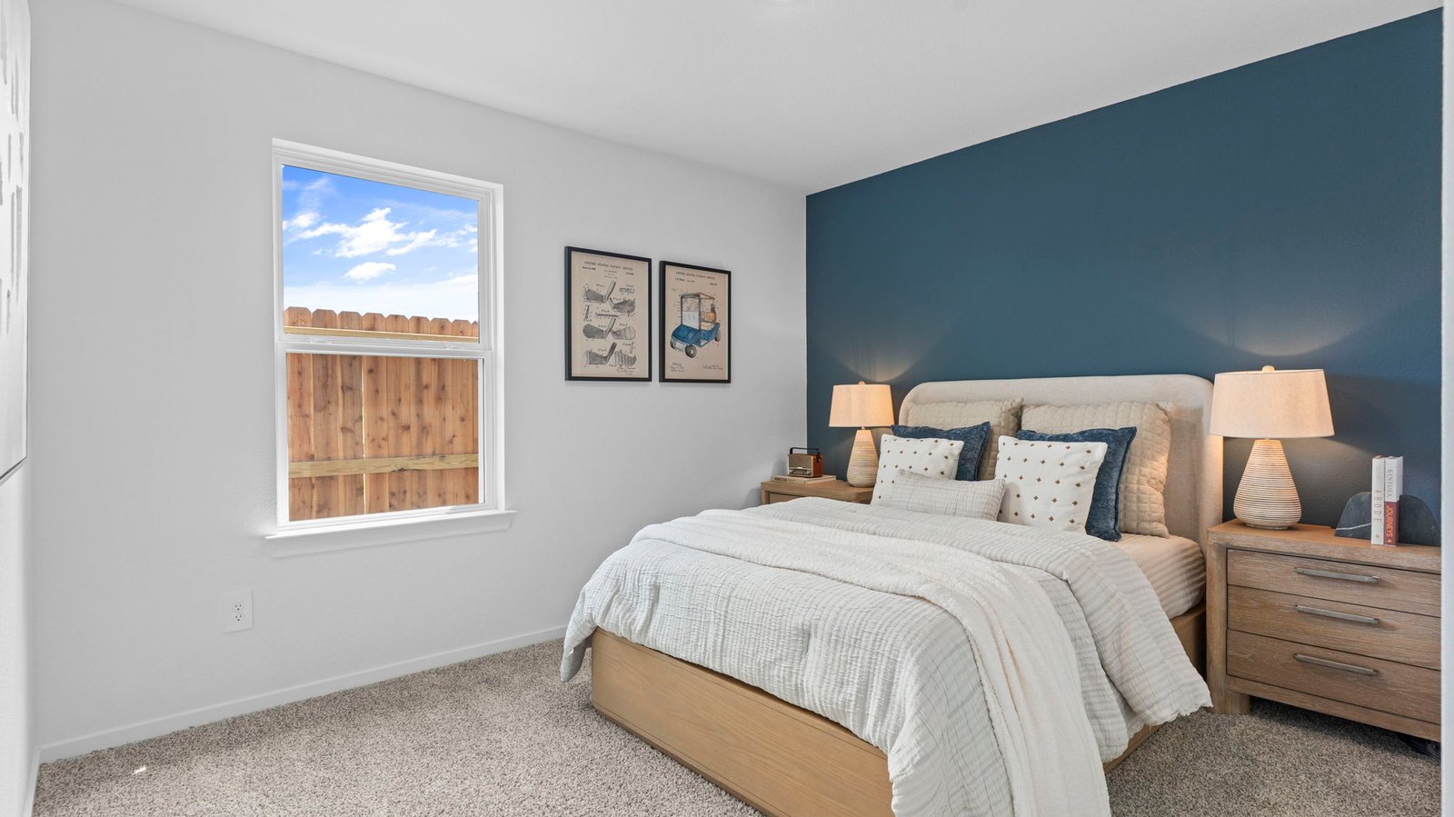 A vibrant bedroom showcasing a neatly made bed, a stylish dresser, and a playful painting that adds charm.