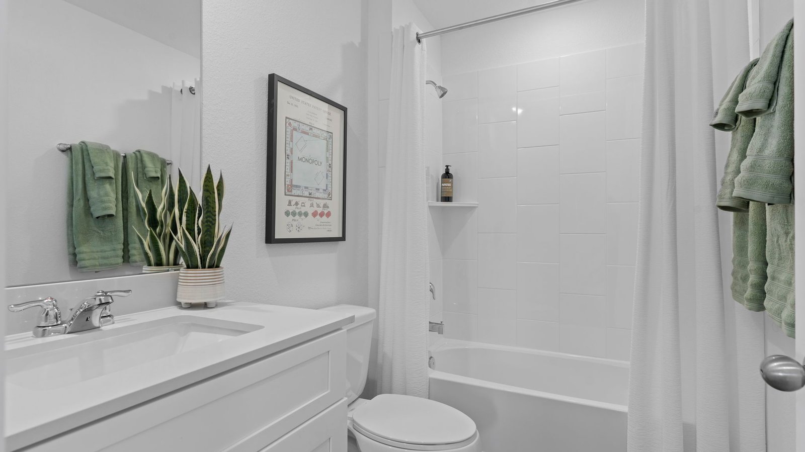 A well-designed bathroom equipped with quartz countertops, a standing tub, and a single vanity.