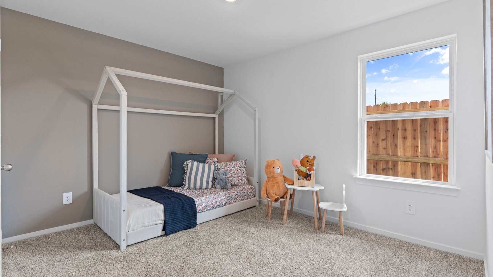 Comfortable guest bedroom featuring neutral-toned walls, carpeted flooring, and a separate closet.