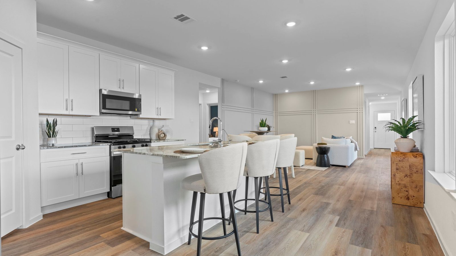 Kitchen adorned with painted cabinets seamlessly integrated into an open dining area layout.