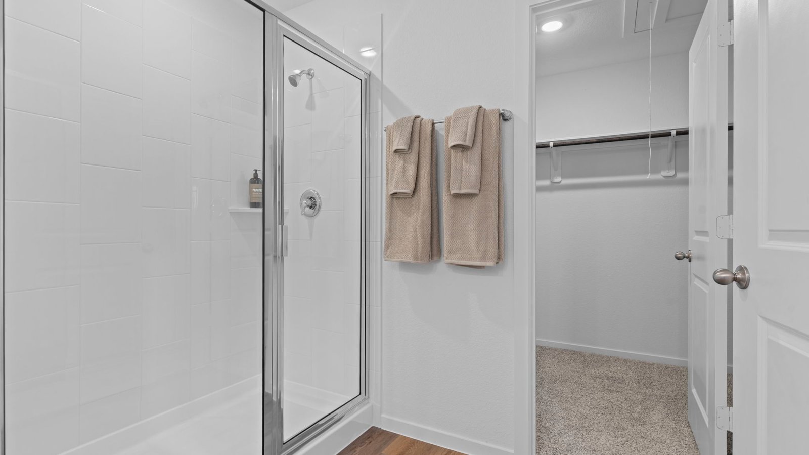 Primary bathroom with a glass-enclosed standing shower and separate soaking tub.