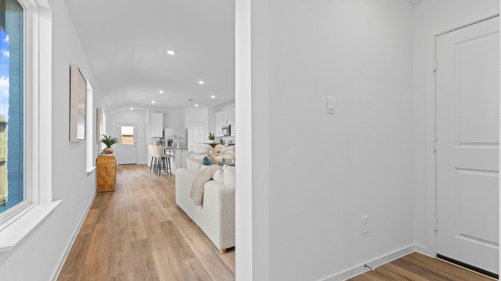 Entry hallway leading to living room and kitchen in the background.