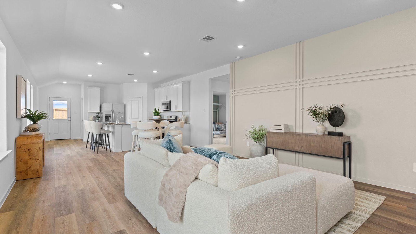 A well-organized living room that includes a kitchen and dining area, creating a warm and welcoming environment for gatherings.