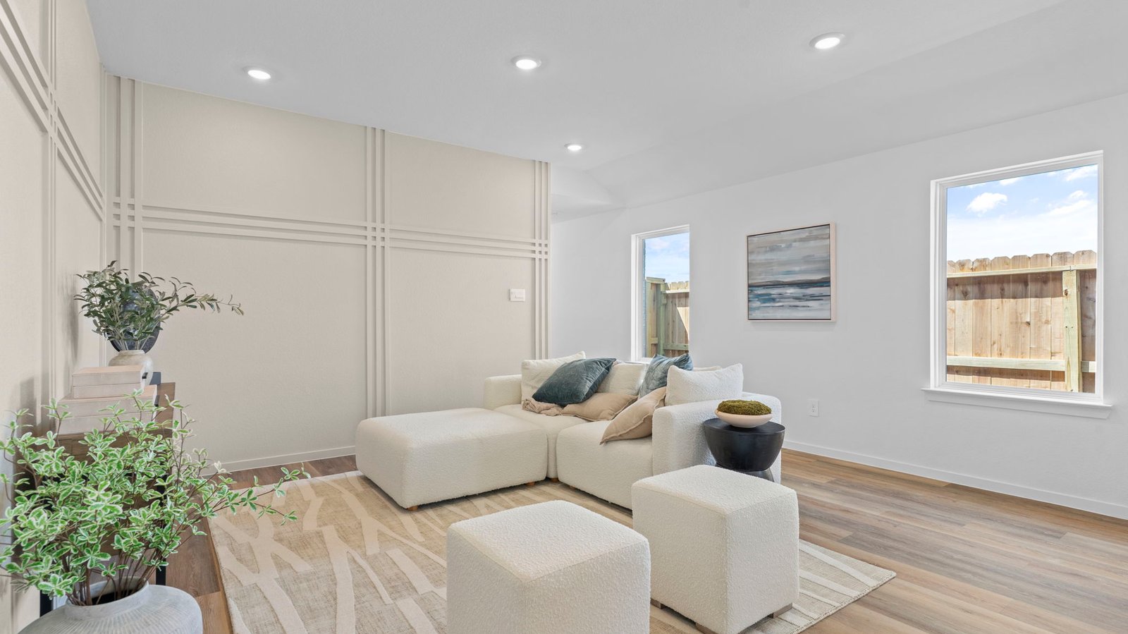 A cozy living room featuring a comfortable couch, a stylish coffee table, and an elegant painting on the wall.