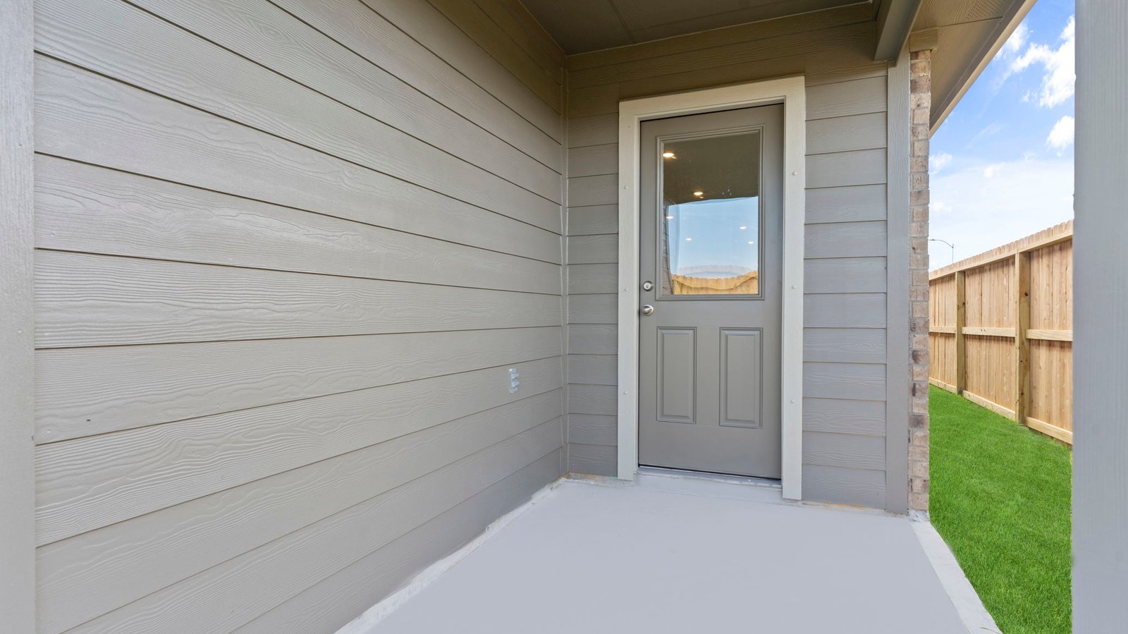 Outdoor covered patio with room for outdoor furniture to enjoy the backyard in those cooler months